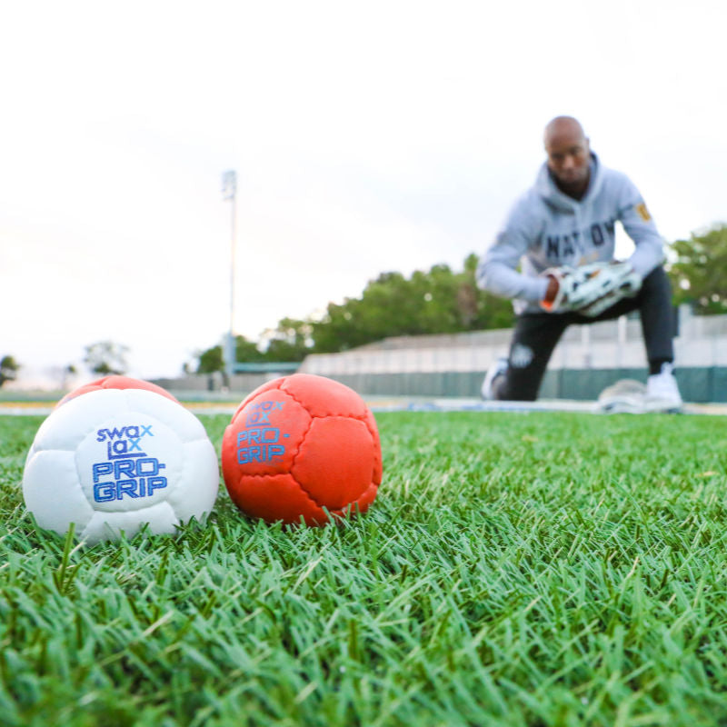 Swax Lax Pro-Grip lacrosse training balls in grass with Chazz